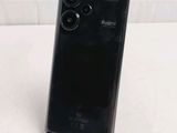 the back of a black cell phone sitting on top of a table