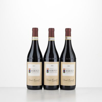 three bottles of red wine sitting on top of a table