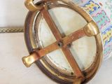 a gold and white vase with a clock on it