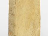 an old book sitting on top of a white surface