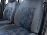 two seats in the back of a car with a blue seat cover