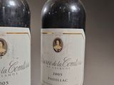 two bottles of wine sitting next to each other on a table