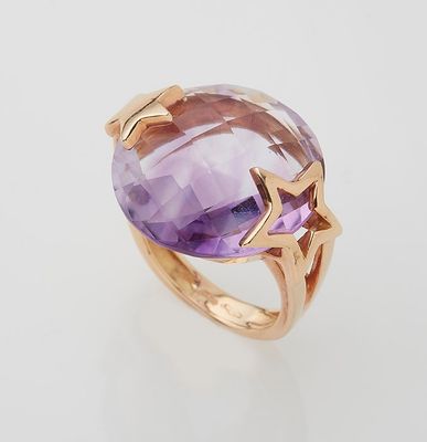 a close up of a ring with an amethorate and a star