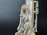 a silver saxophone that is sitting on a table