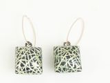 black and white square earrings with silver wire on a white background
