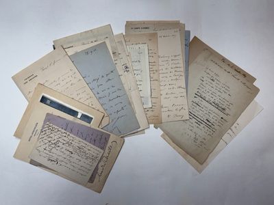 several old papers are stacked on top of each other on a table