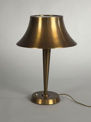 an image of a brass table lamp on a white background
