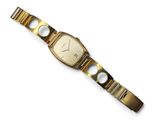 a close up of a watch on a white surface with a white background