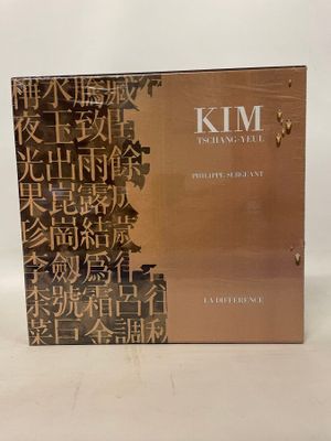 a close up of a box of perfume on a white surface