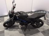 a motorcycle that is sitting on a checkered floor