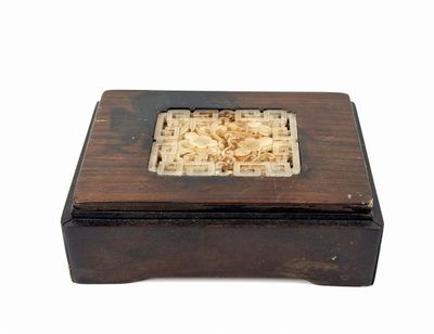 a small wooden box with a carved design on it