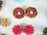 many different types of earrings on a white surface