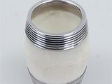 a close up of a silver plated cup on a white surface