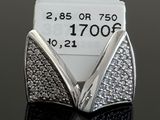 a close up of a pair of earrings on a table with a price tag