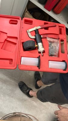 a red case with tools in it on the floor