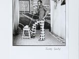 black and white photograph of a man standing in front of a table