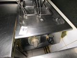 a silver stove top with a bunch of cooking utensils on it