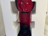 a red coffee maker sitting on top of a white box
