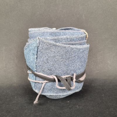 a close up of a pair of jeans with a tie around it
