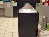 a black counter with a sink in the middle of a room