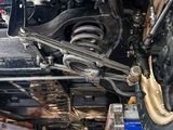 a close up of a car under a vehicle in a garage