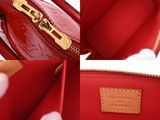 the inside of a red louis vuitton bag