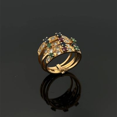 a close up of a gold ring with multi colored stones