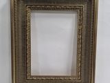 a gold picture frame on a white background