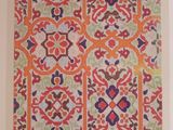 a painting of an orange and blue pattern on a white wall