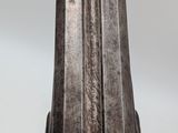a close up of a metal object on a white surface
