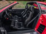 the interior of a red sports car with its doors open