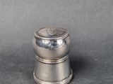 silver plated salt and pepper shaker on a grey background