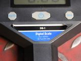 a digital scale sitting on top of a red table