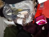 a cat that is sitting in a pile of clothes