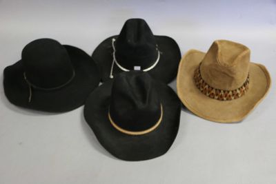 several hats are lined up on a white surface