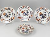 three plates and a bowl with floral designs on them on a table