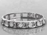 a close up of a diamond ring on a reflective surface