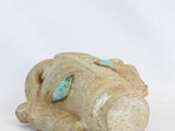 pair of ceramic figurines of a man and a woman with turquoise eyes