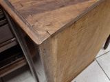 a wooden box sitting on a tile floor next to a computer