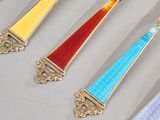 five spoons with different colors and designs on them