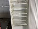 an empty refrigerator in a small kitchen with no door