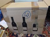a cardboard box that has three bottles of wine in it