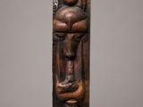 a wooden sculpture of a woman holding a child