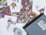 a lot of children ' s drawings and pictures on the table