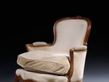 an image of a chair and ottoman in a dark room