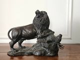 a statue of a lion standing on a rock on a table