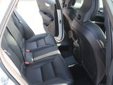 a white car with black seats and a door open