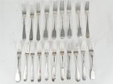 a lot of forks and spoons on the table