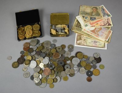 a lot of coins and a box of money on the table
