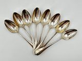 five spoons in the shape of tulips on a white surface